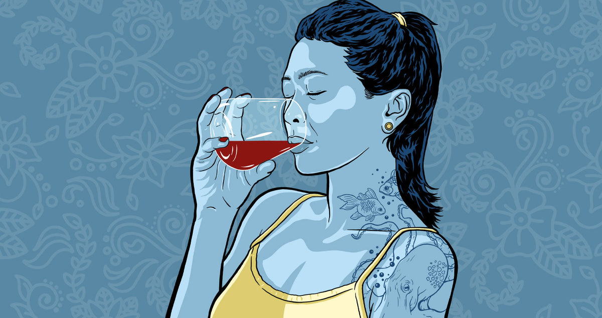 Tattooed woman drinking alcohol for alcohol tattoo article Alcohol and Tattoos - Everything You Need to Know
