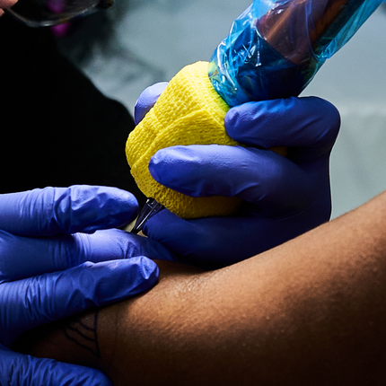 Artist tattooing with a strong stretch and steady hand