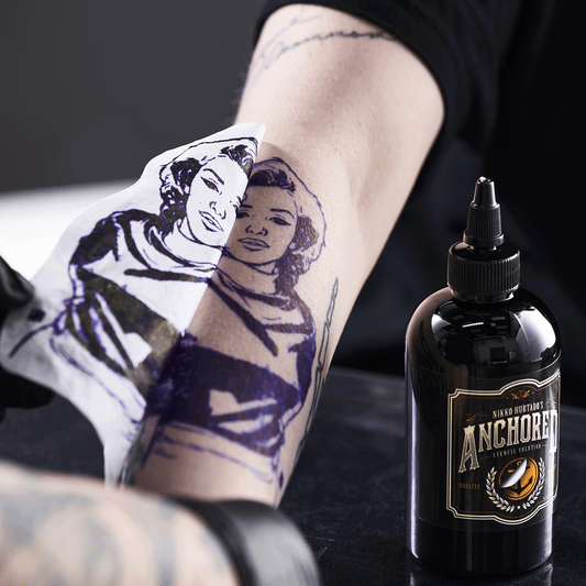 Close-up of tattoo stencil being revealed on client's skin