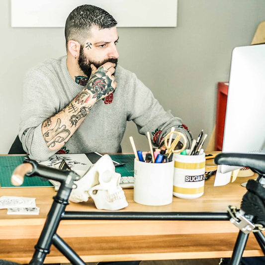 Tattoo artist at a desk doing taxes