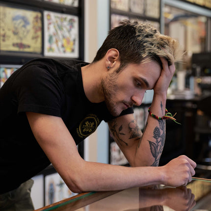 Tattoo artist looking stressed out at a front desk
