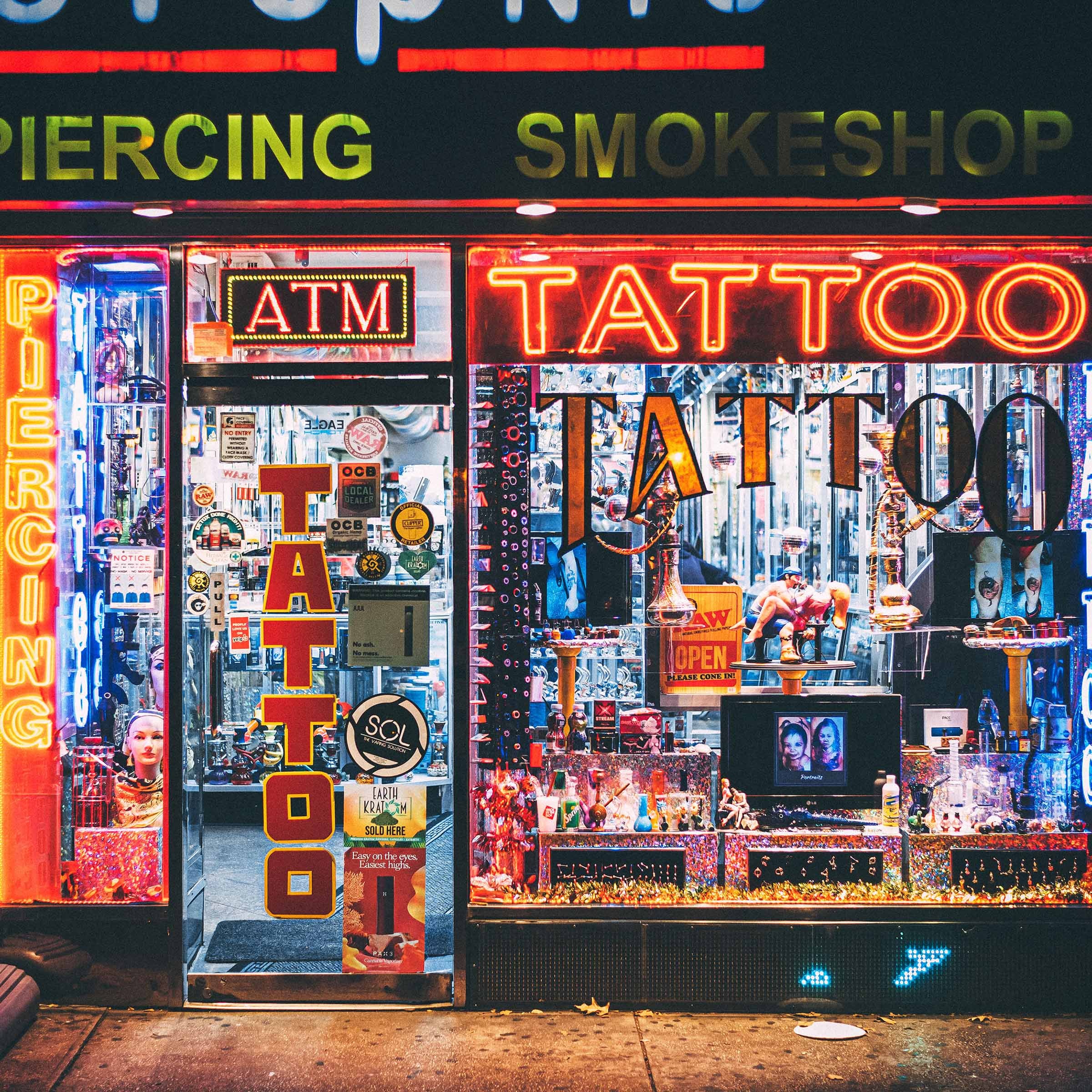 Front of a tattoo shop with neon signs How to Expertly Market Your Tattoo Shop