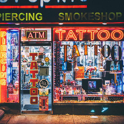 Front of a tattoo shop with neon signs