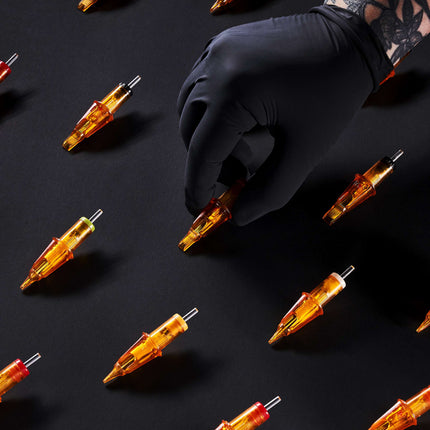 Array of Peak Triton cartridge needles on a black backdrop