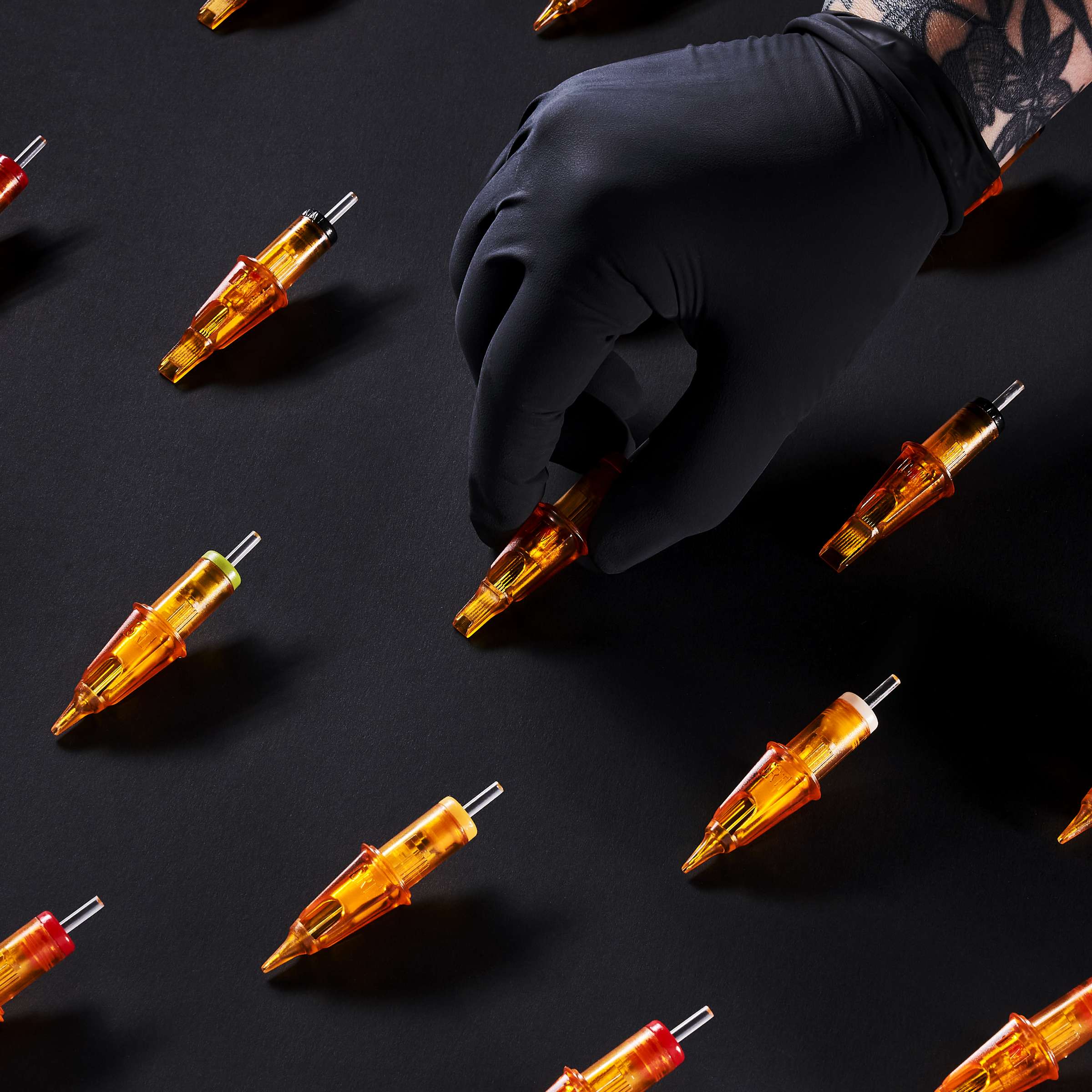 Array of Peak Triton cartridge needles on a black backdrop PainfulPleasures x Peak Triton Needles Giveaway
