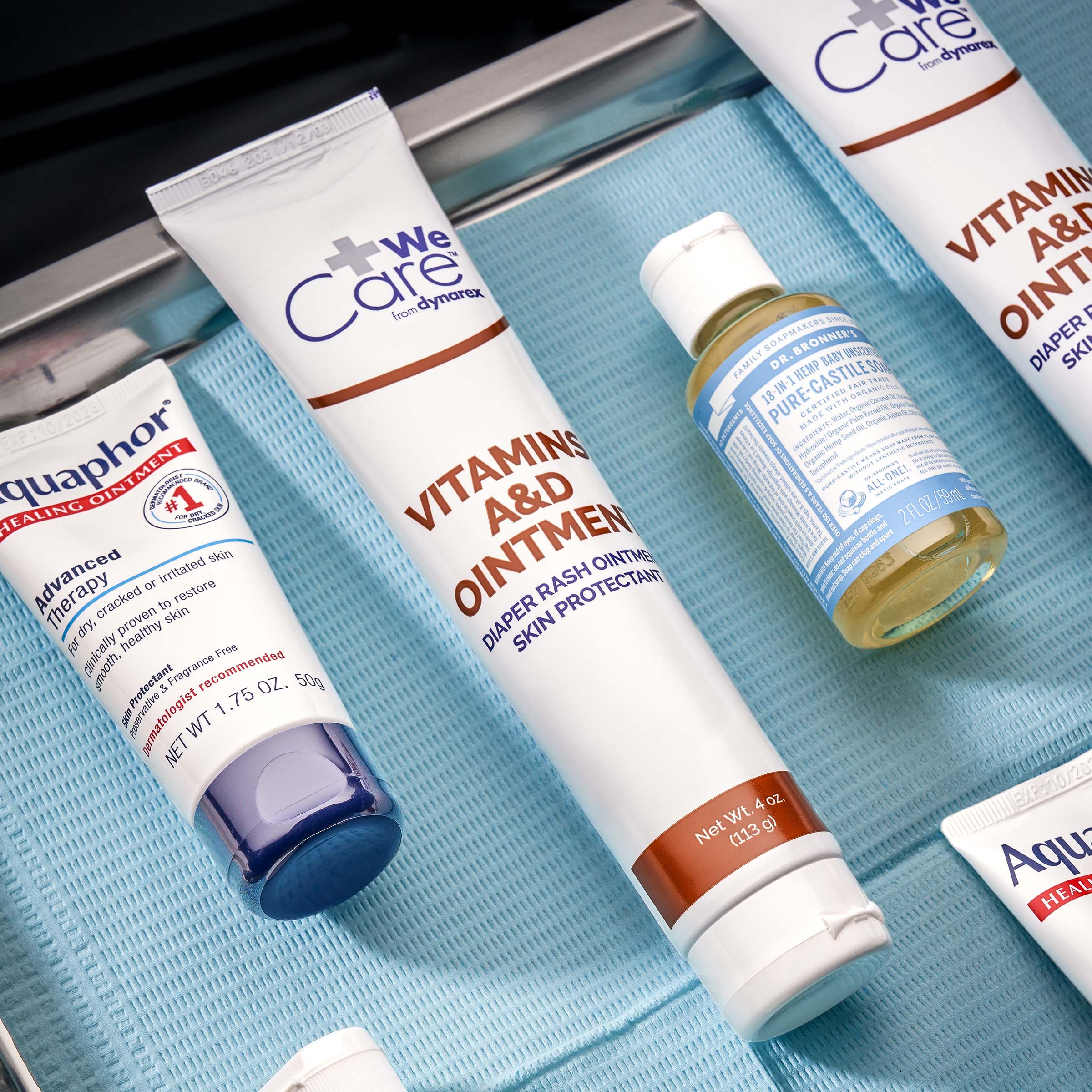 Stainless steel medical tree with dental bib holding aftercare supplies Your Guide to Tattoo Aftercare