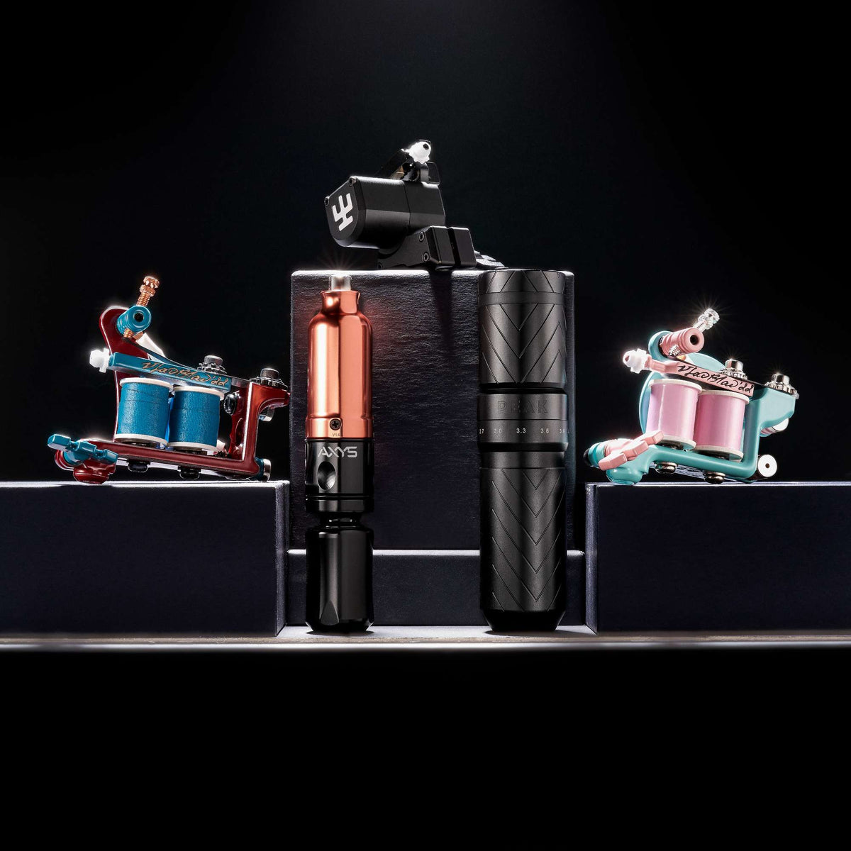 Group shot of a variety of coil and pen-style rotary tattoo machines