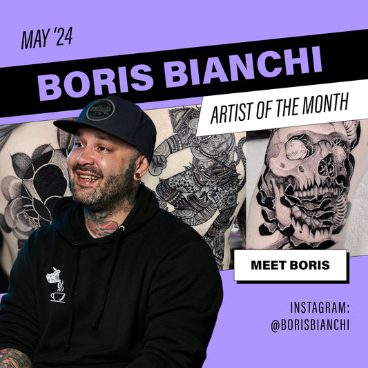 Blackwork and fine line tattoo artist Boris Bianchi posing in front of a series of his tattoos