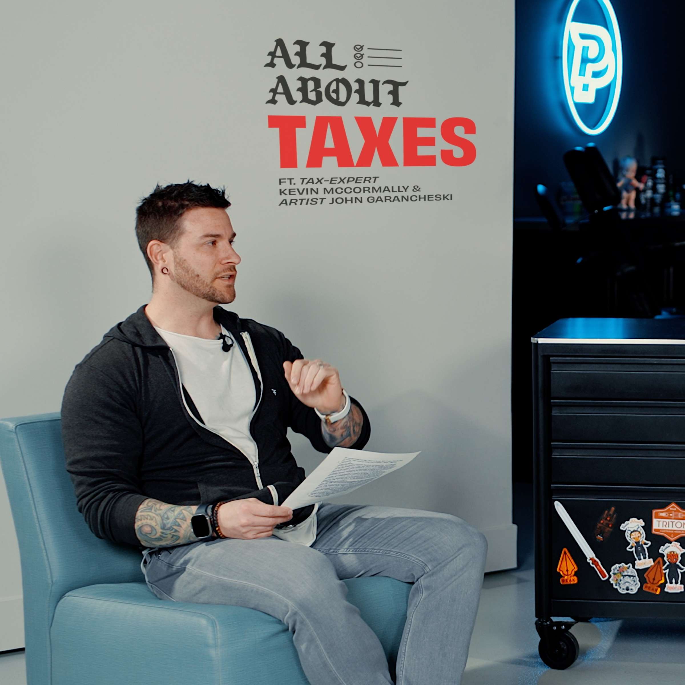 Tattoo artist John Garancheski in a chair VIDEO ROUNDUP: All About Taxes Series with Tax Expert Kevin McCormally
