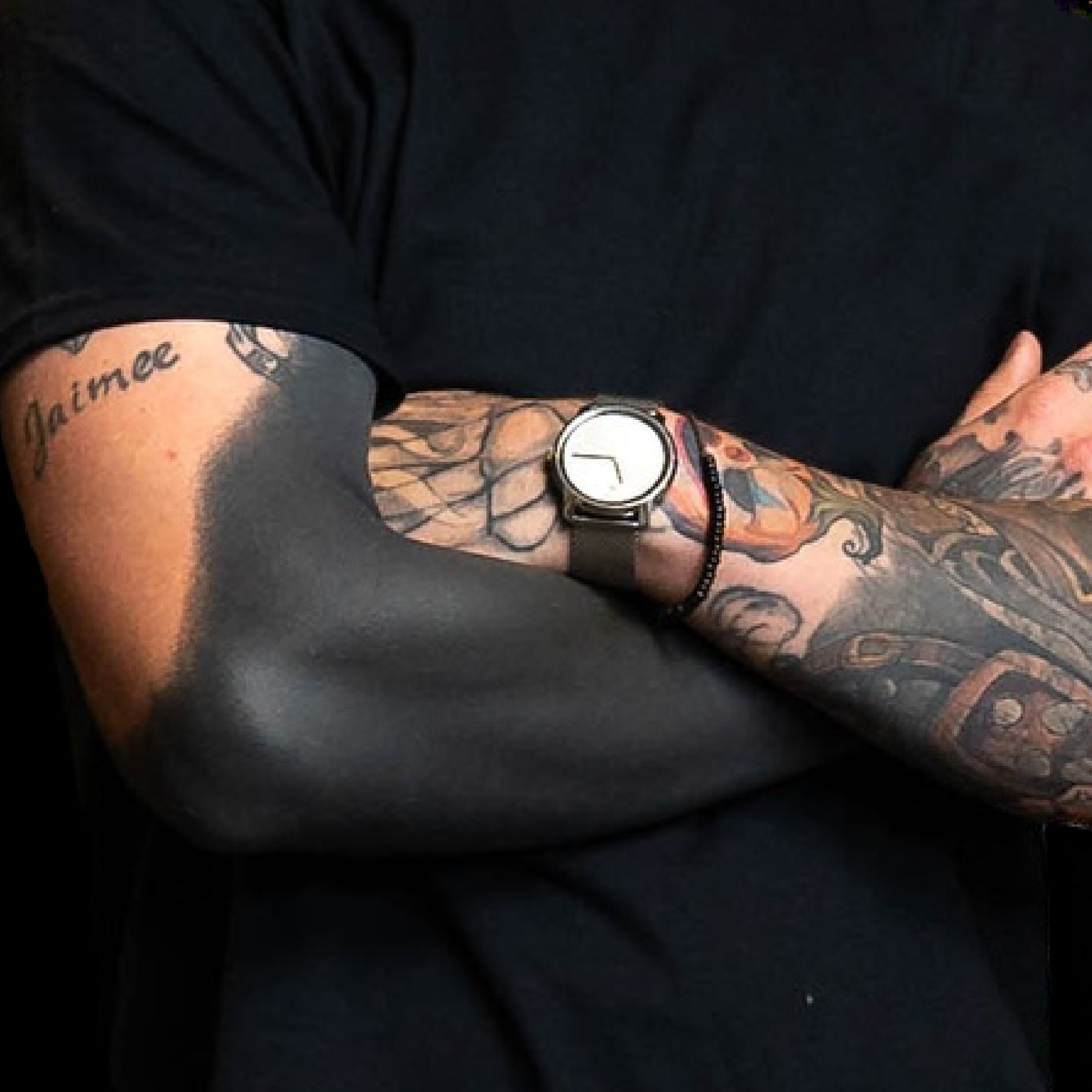 Closeup of tattoo artist Gonzo's blackout sleeve tattoo