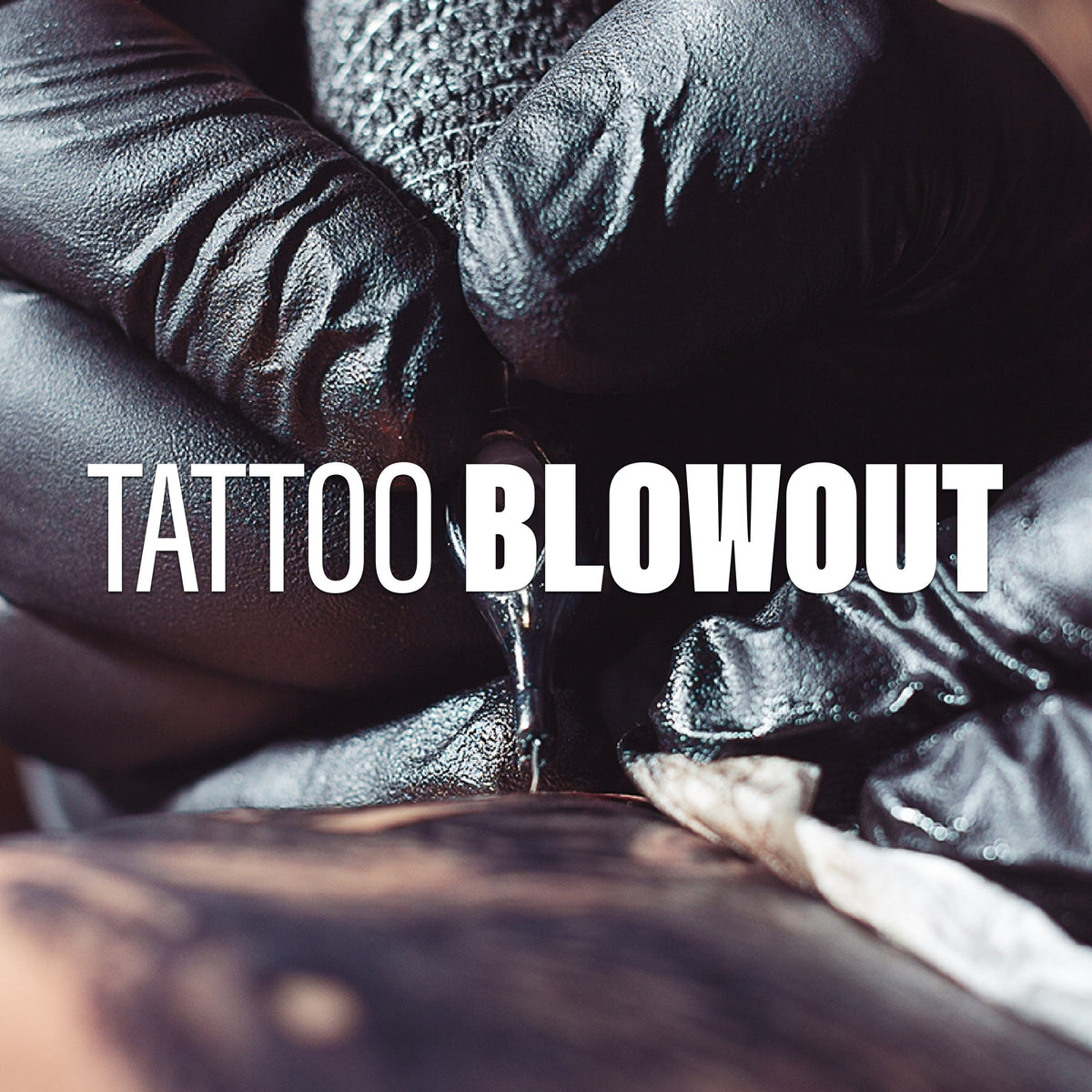 An artist tattooing a client.