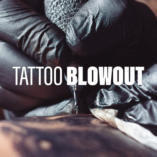 An artist tattooing a client.