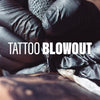 An artist tattooing a client.