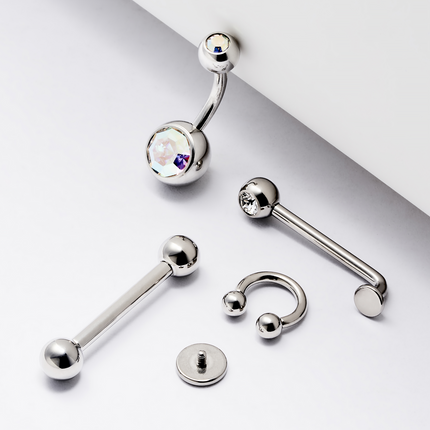 Collection of stainless steel body jewelry on a white backdrop
