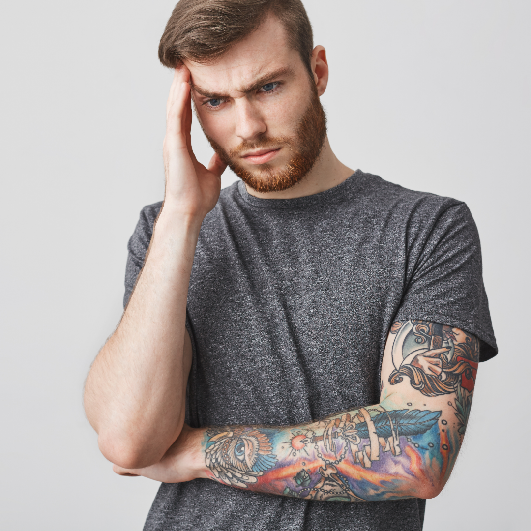 Tattoo artist looking frustrated