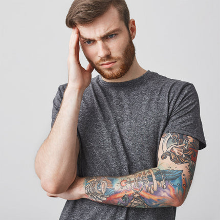 Tattoo artist looking frustrated