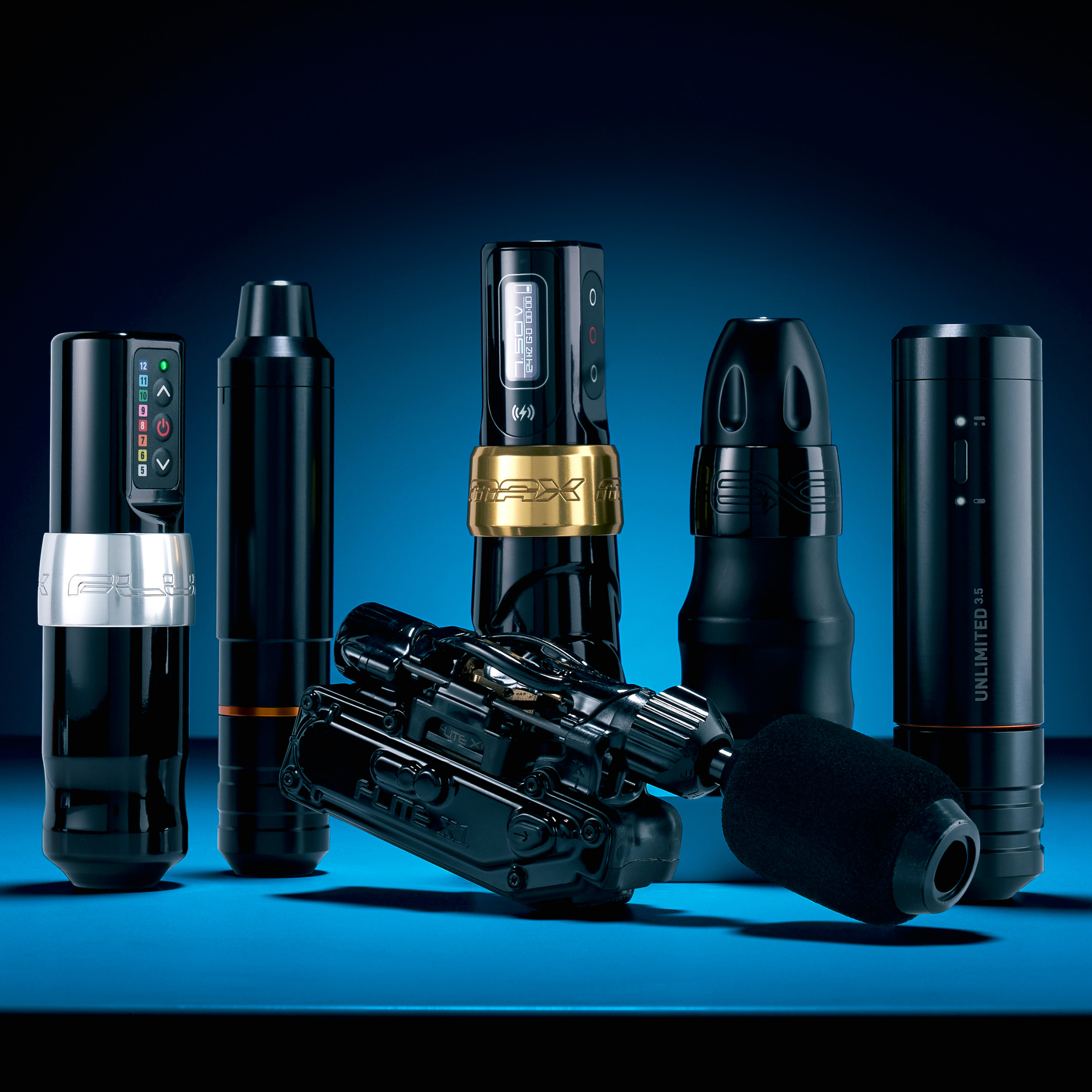 Group shot of rotary tattoo machines with a blue backdrop Tattoo Gun vs. Tattoo Machine - Understanding the Correct Tattoo Terminology