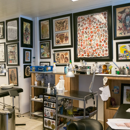 Empty tattoo shop with flash sheets framed on the walls
