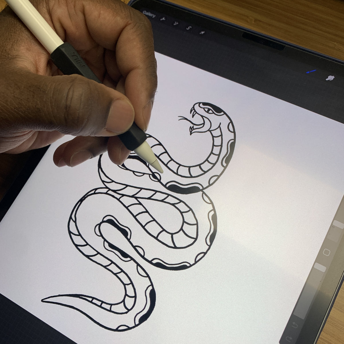 Tattoo artist creating a snake tattoo stencil design