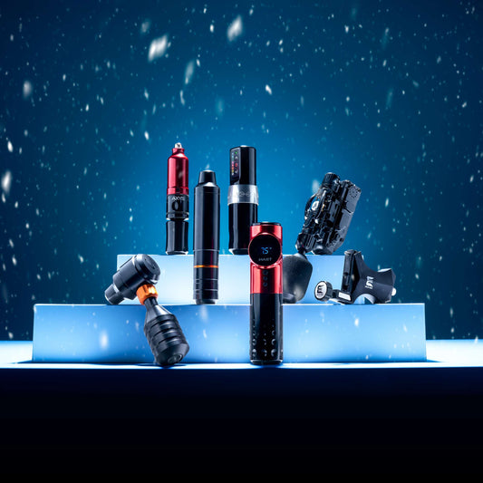 Selection of rotary tattoo machines on tiered white platforms with snow in the background