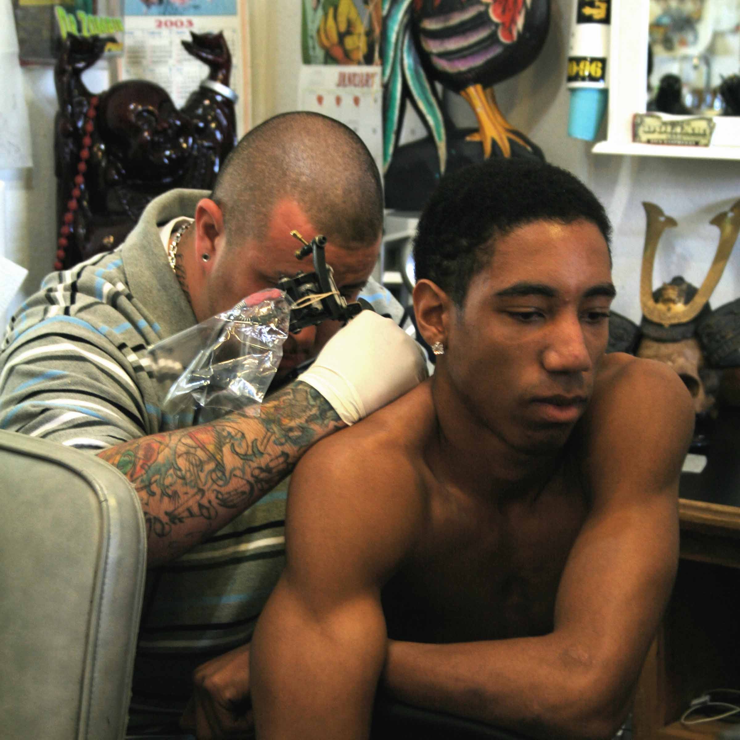 Black client getting a back tattoo What to Know about Tattooing Darker Skin Tones