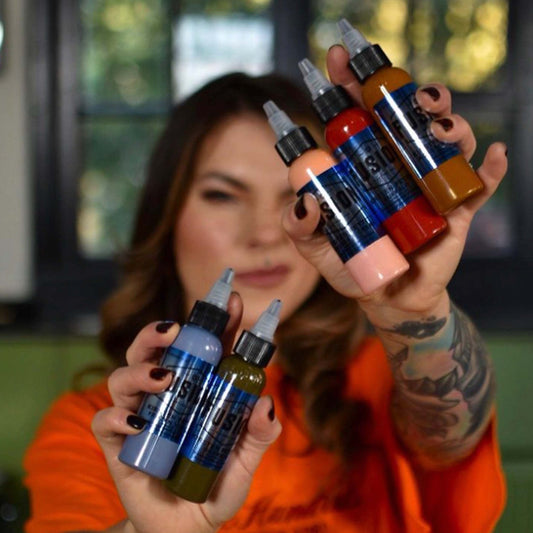 Tattoo artist Kristen Pettitt holding Fusion Inks from her custom ink set