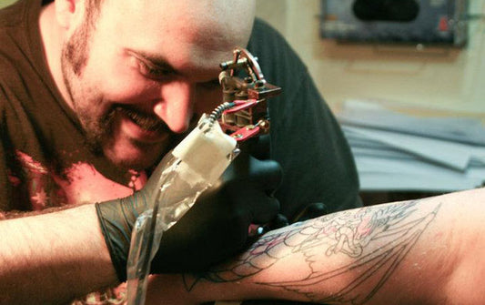 Mark Keller of Chameleon Ink Tattooing With Protective Gear Over His Equipment