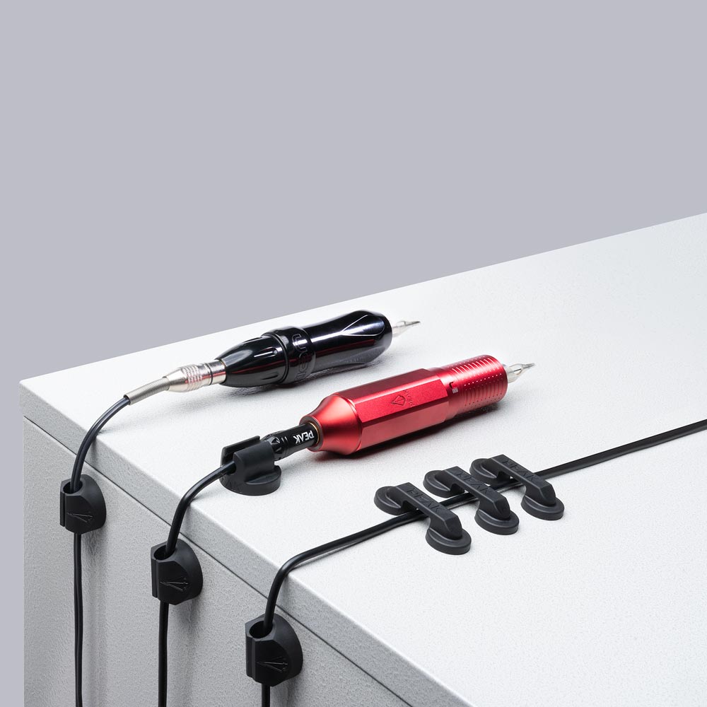 Underside magnet view of Peak Cord Manager on white background