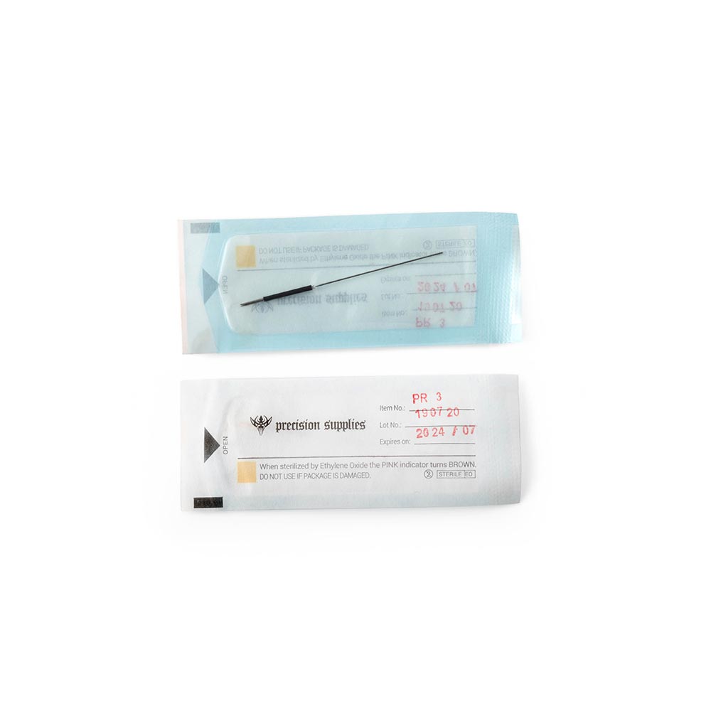 Box of cosmetic tattoo needles with one sterilized needle shown