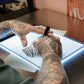 Close up view of micro USB cord and port on Precision Ultra Thin Tracing Light Box for tattoo stencils. Examples of possible connections shown below