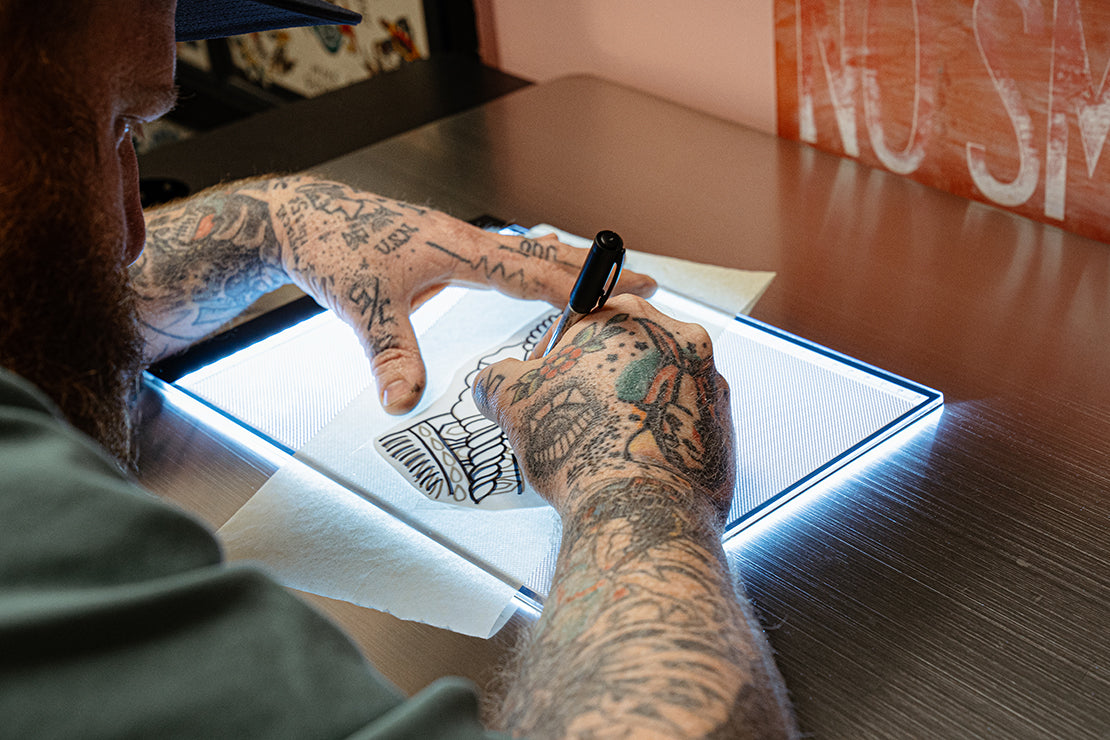 Close up view of micro USB cord and port on Precision Ultra Thin Tracing Light Box for tattoo stencils. Examples of possible connections shown below