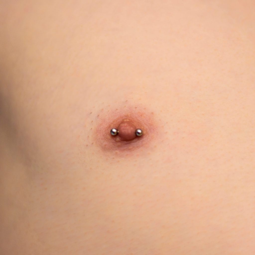 Close-up of a male nipple piercing