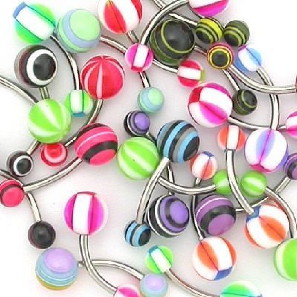 An assortment of belly button rings with colorful ball ends.