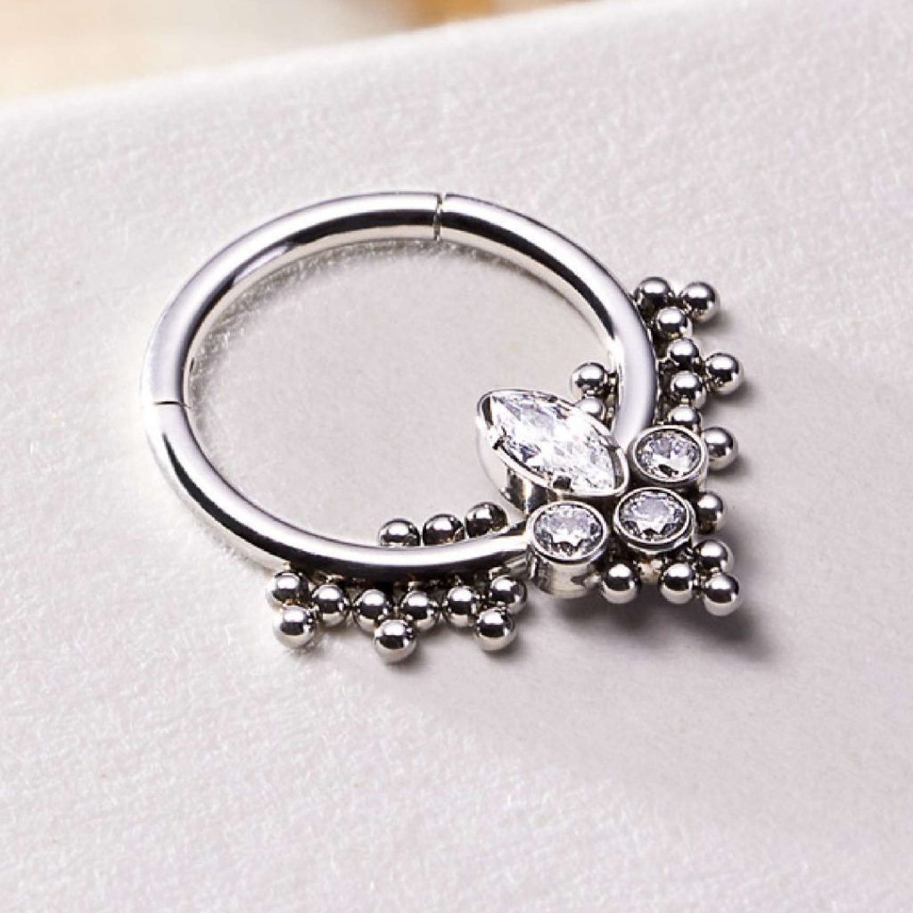 Close-up of a titanium clicker ring with crystal jewels