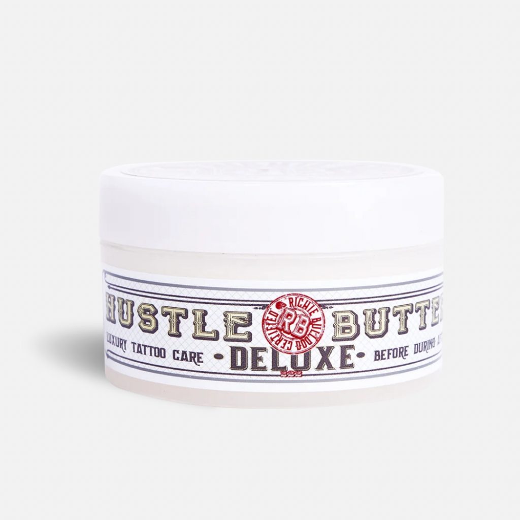 Tub of Hustle Butter Deluxe on a white backdrop