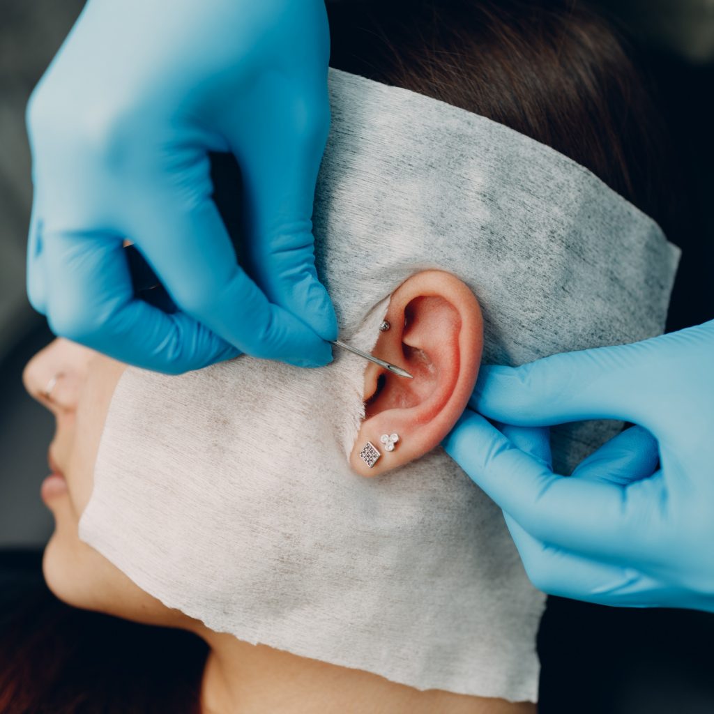 Close-up of a curated ear piercing procedure