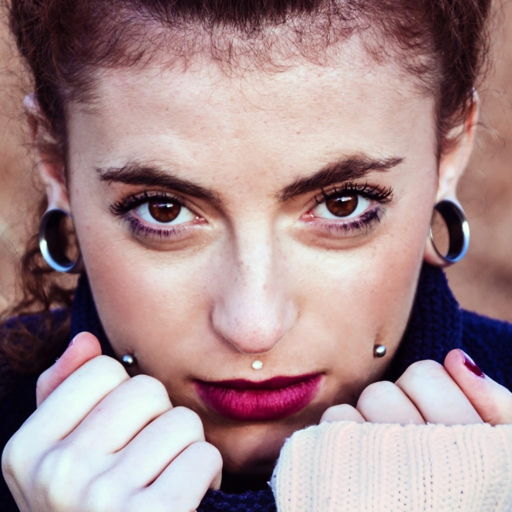 Trendy photo of woman with facial piercings and stretched ears