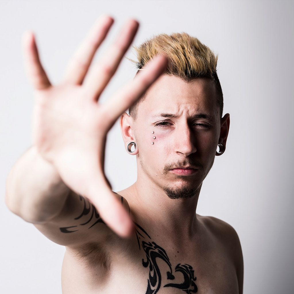 Man with stretched ear lobes looking confident