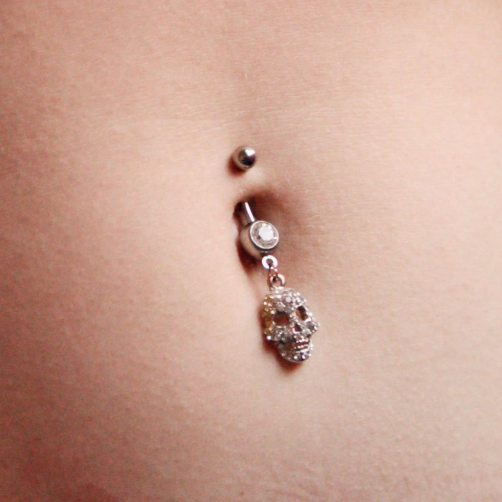 Close-up of dangly navel jewelry