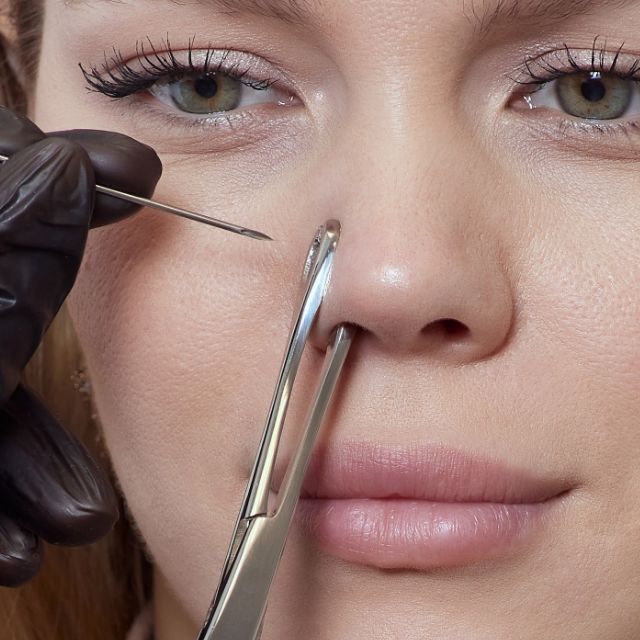 Client getting a nostril piercing