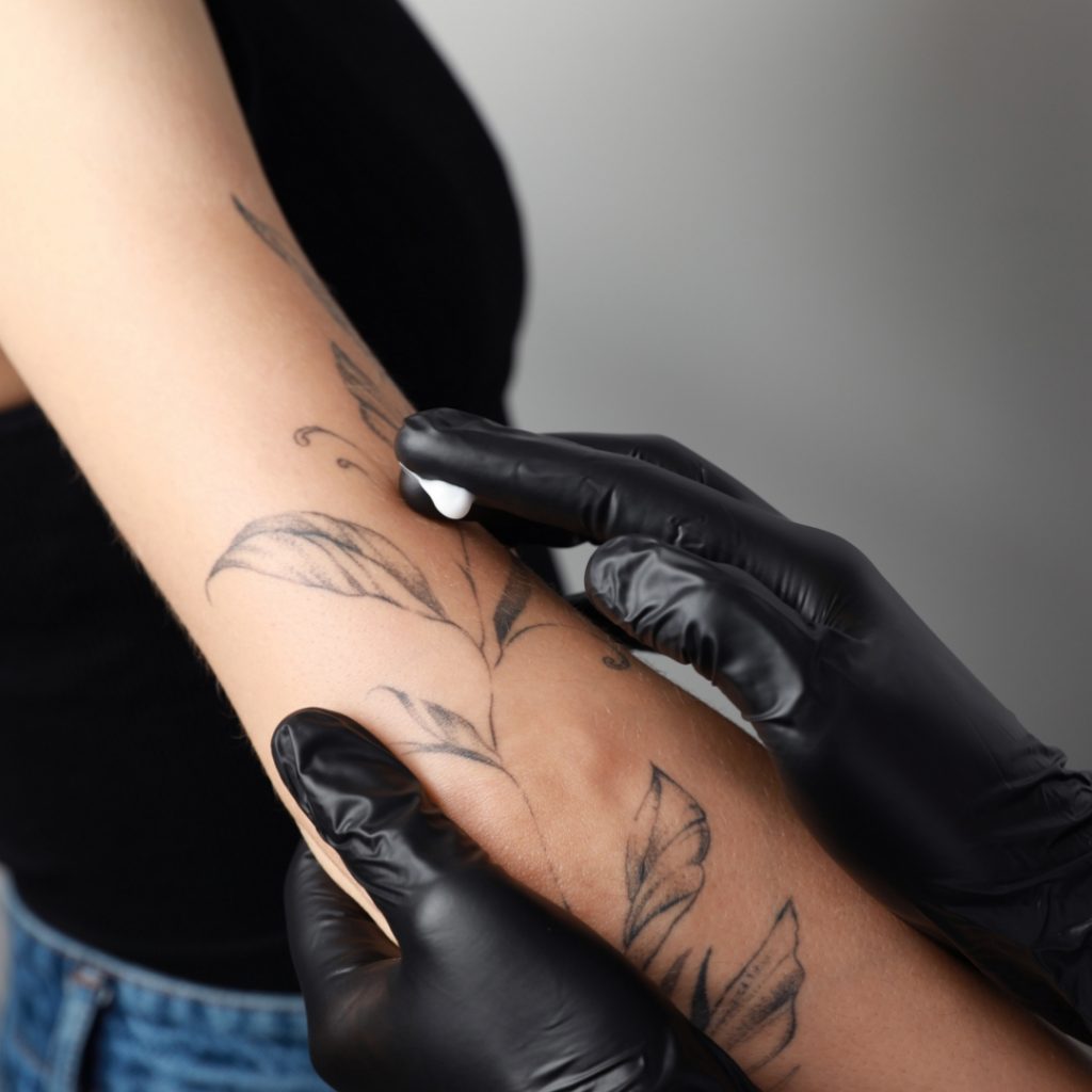 Zoomed out shot of a tattoo being treated with lotion