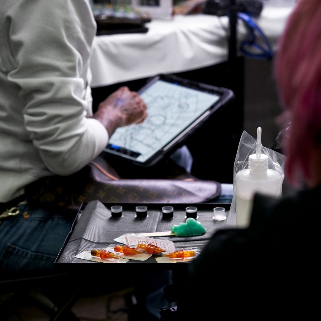 Close-up of tattoo artist working at a tattoo convention