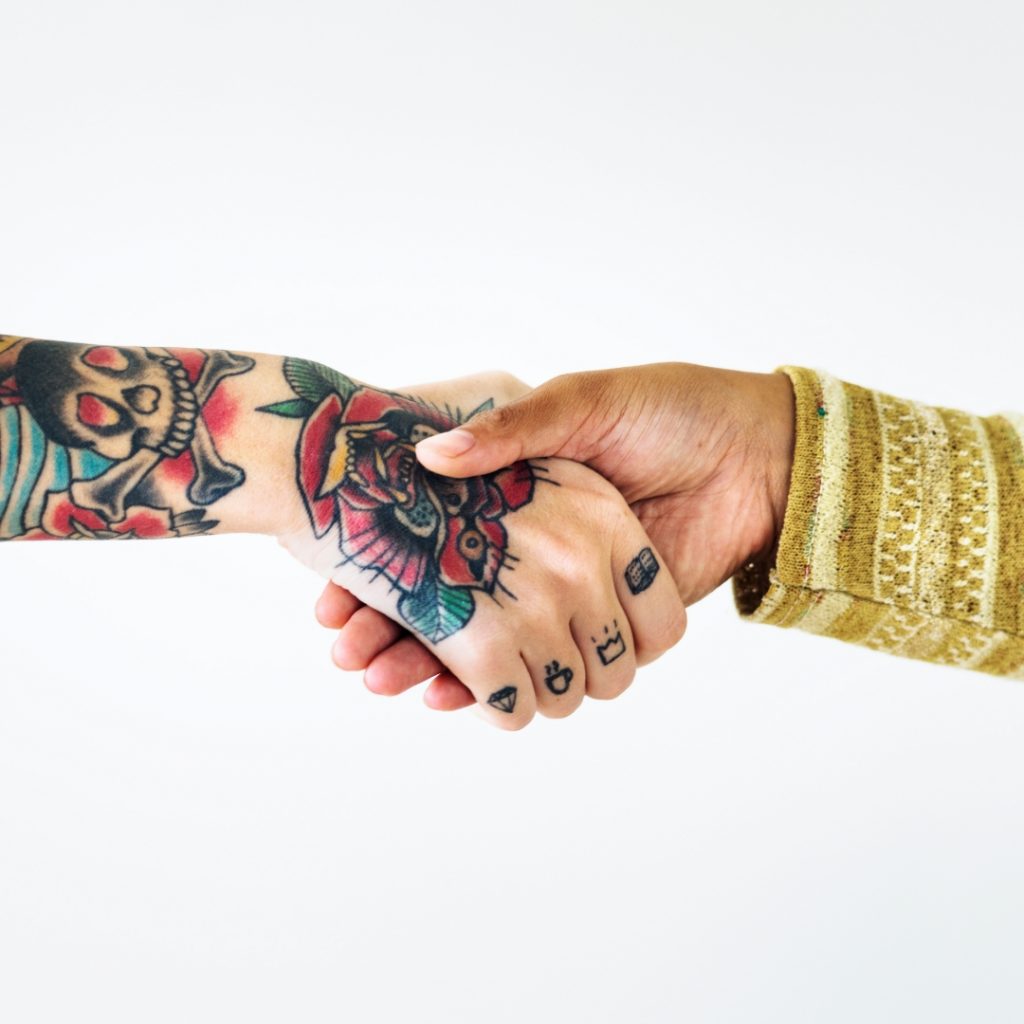 Business handshake between tattoo artist and client