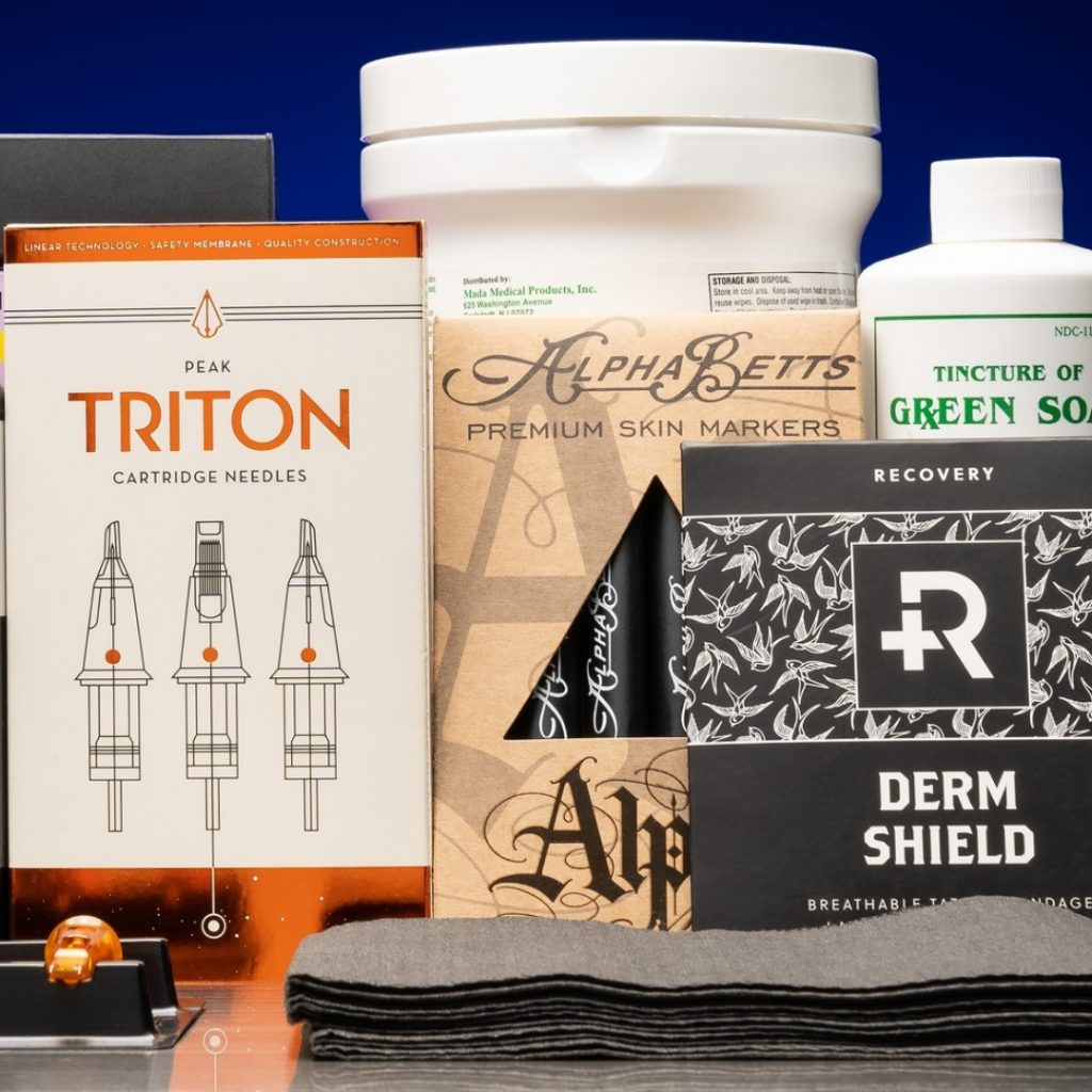 Collection of tattoo supplies for a beginner tattoo kit