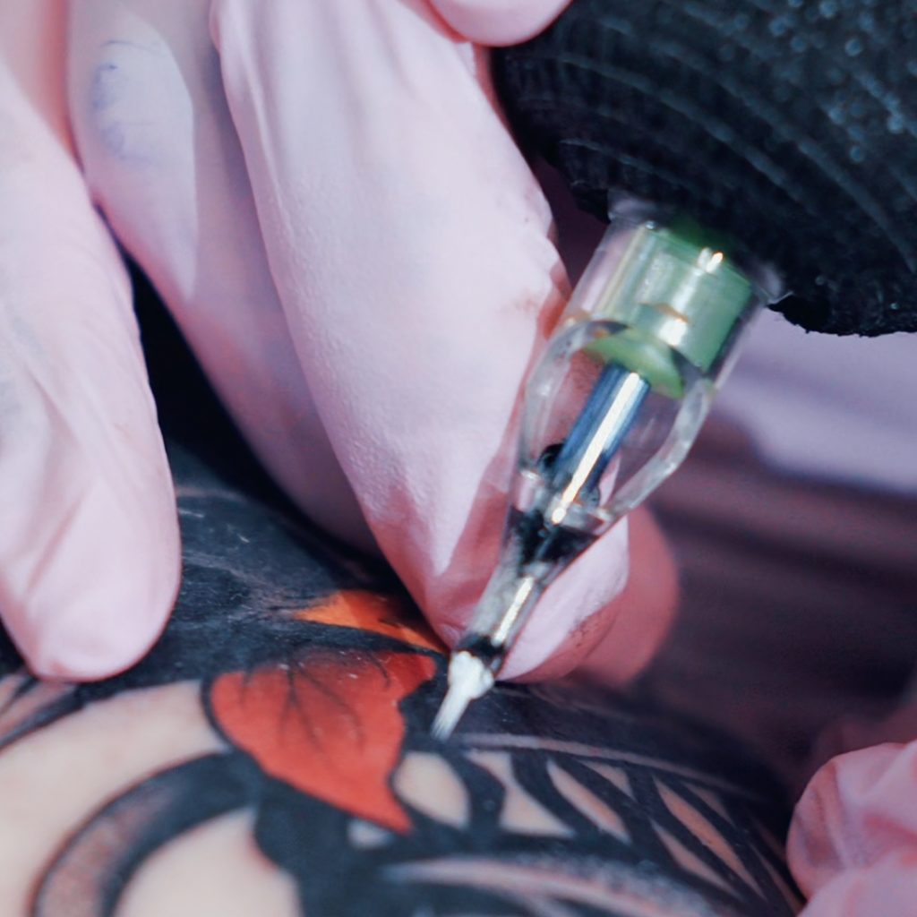 Close-up of a cartridge color packing a tattoo