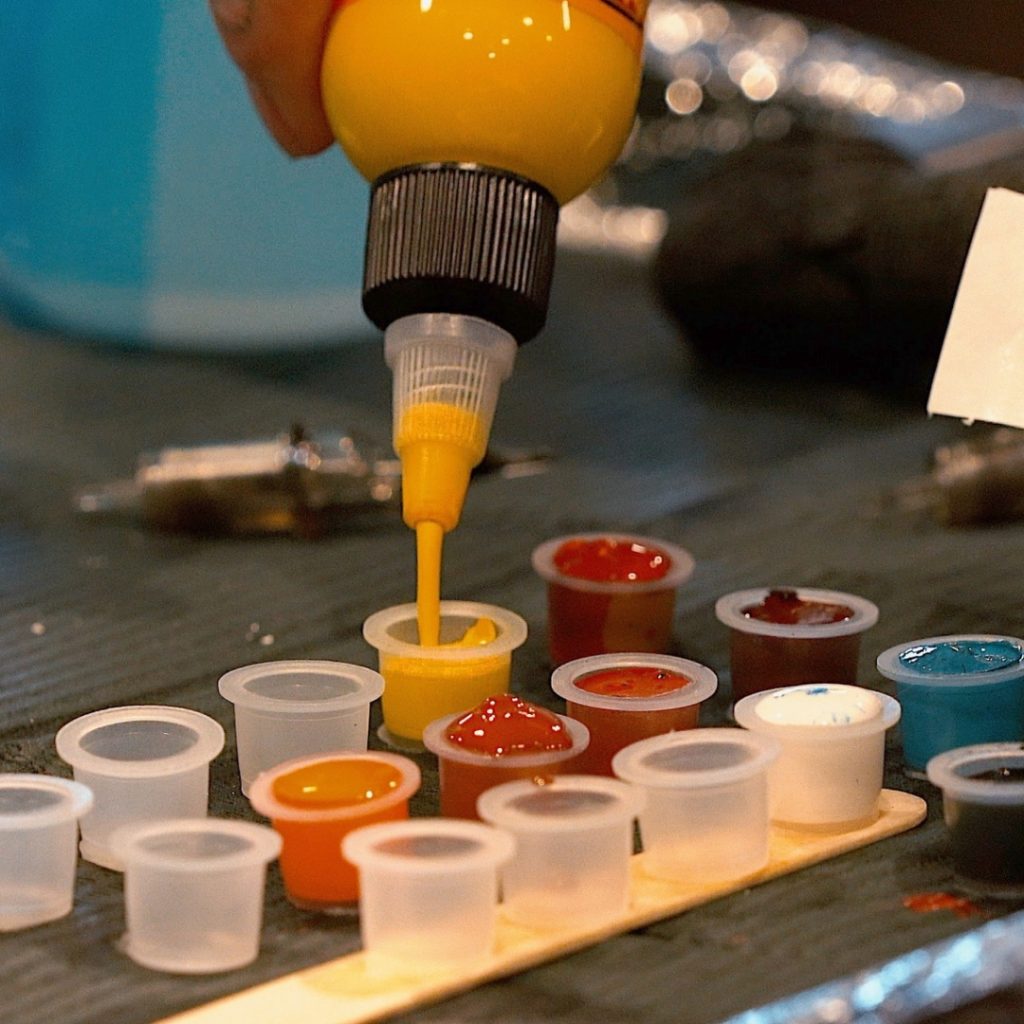 Close-up of a tattoo artist's palette for a color tattoo
