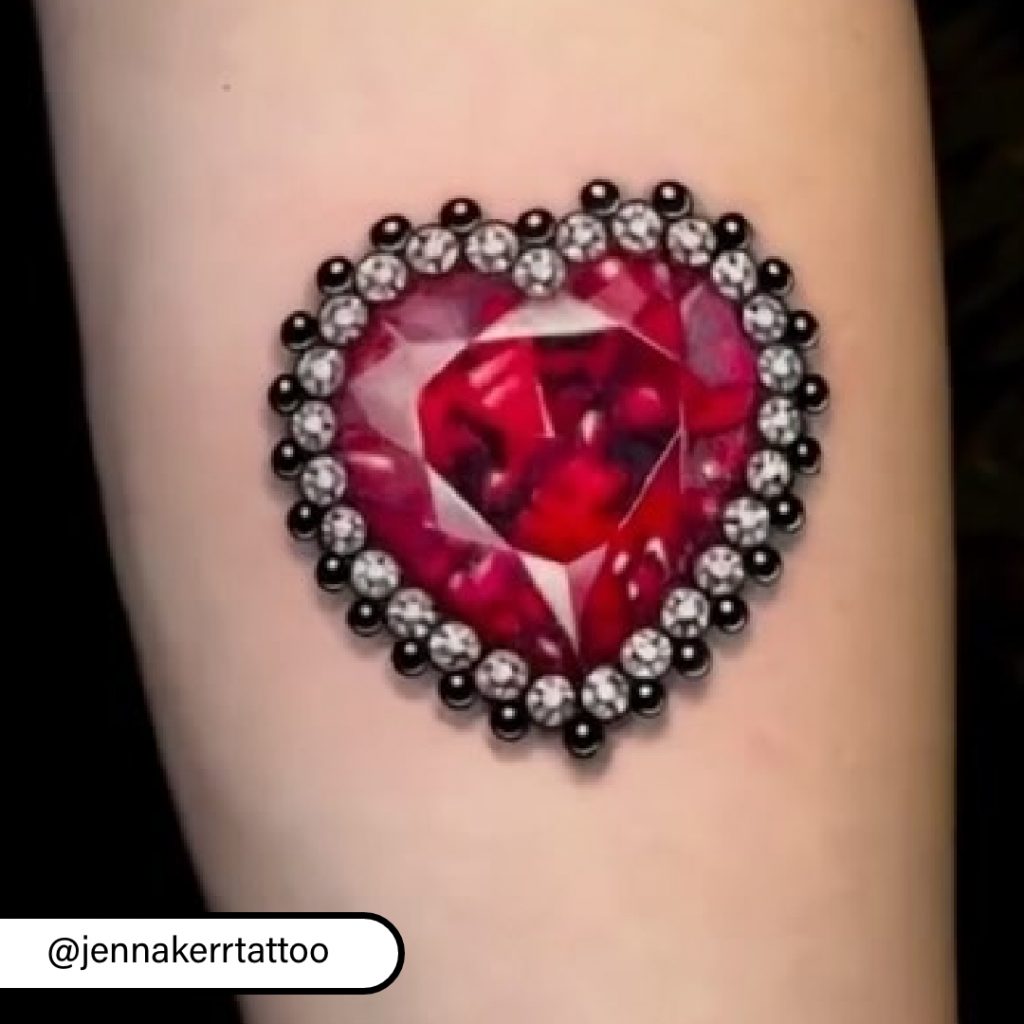 Close-up of heart-shaped ruby tattoo by Jenna Kerr