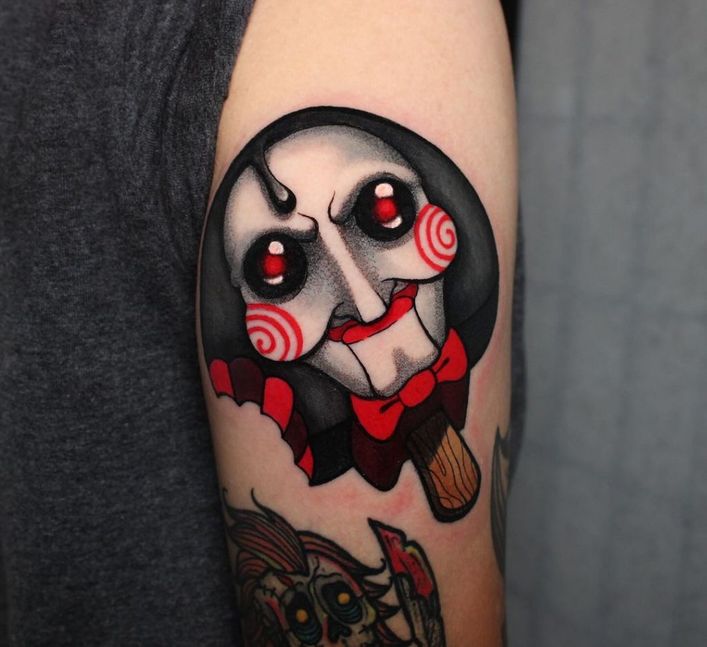 Saw tattoo with red, white, and black shading by @kathleensanders