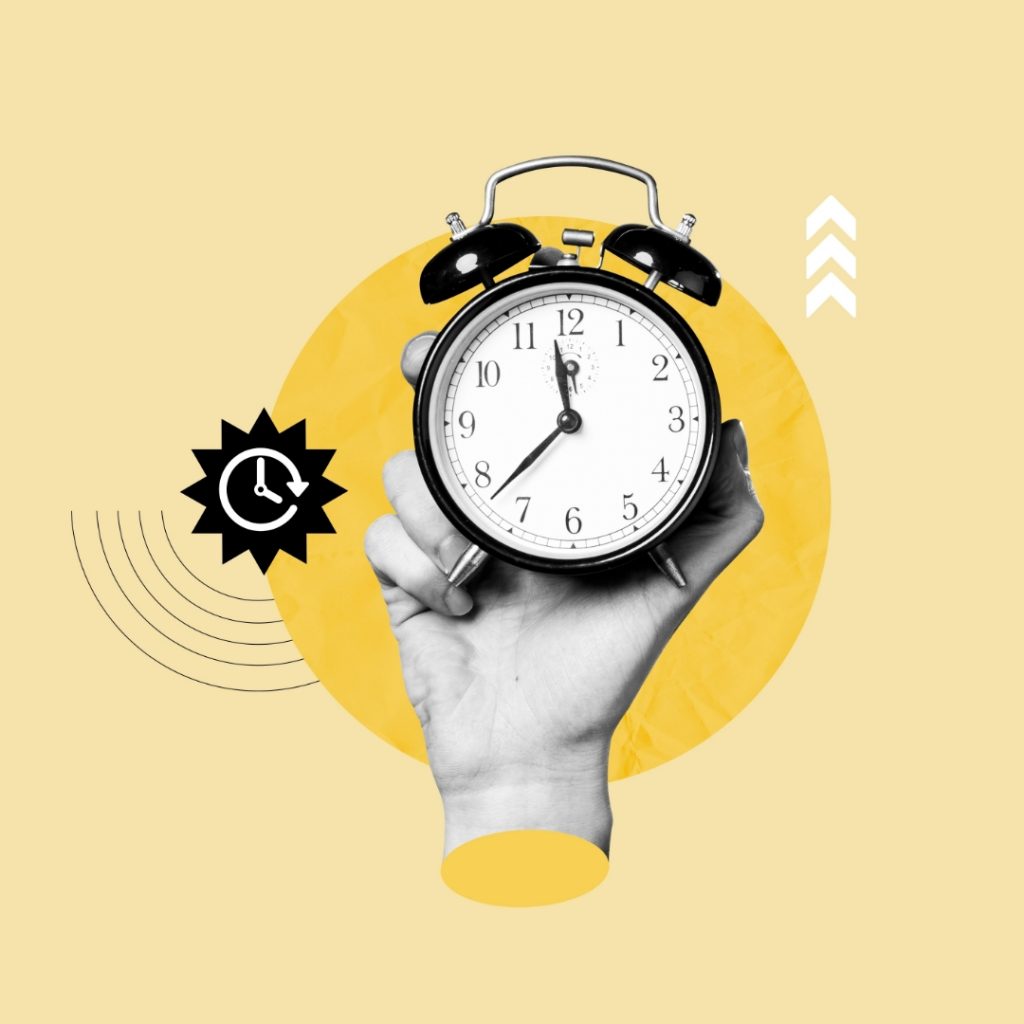 Hand holding up a clock.