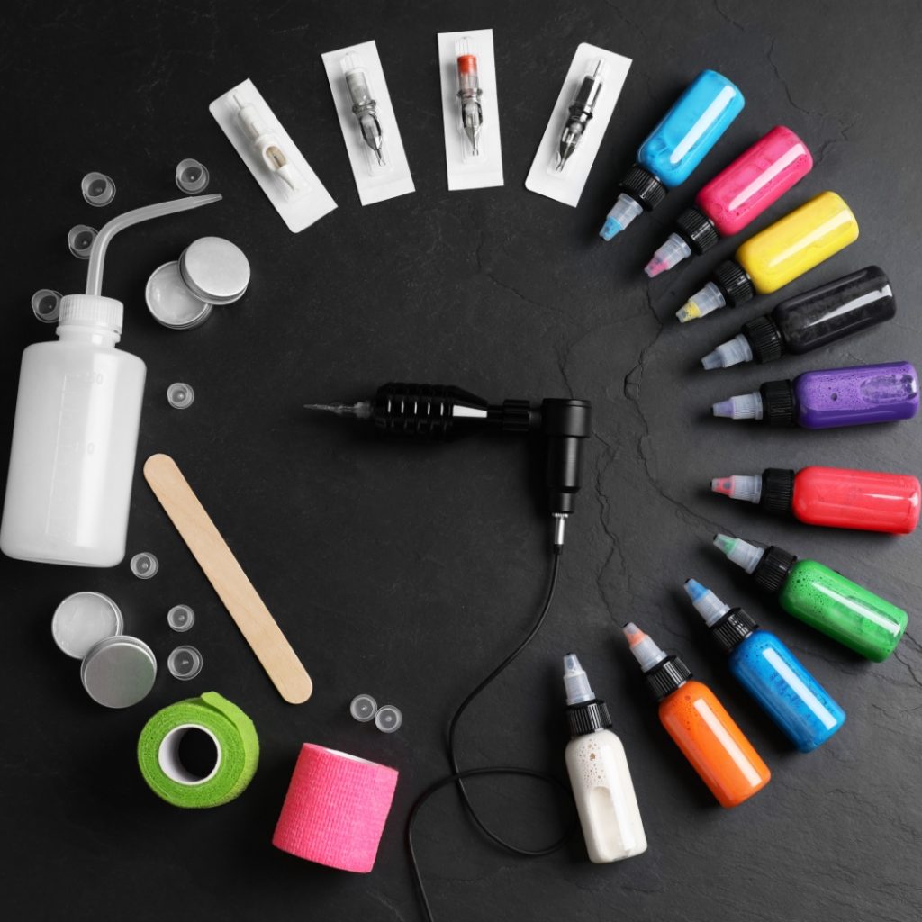 Various tattoo inks, needles, supplies, and a tattoo machine.